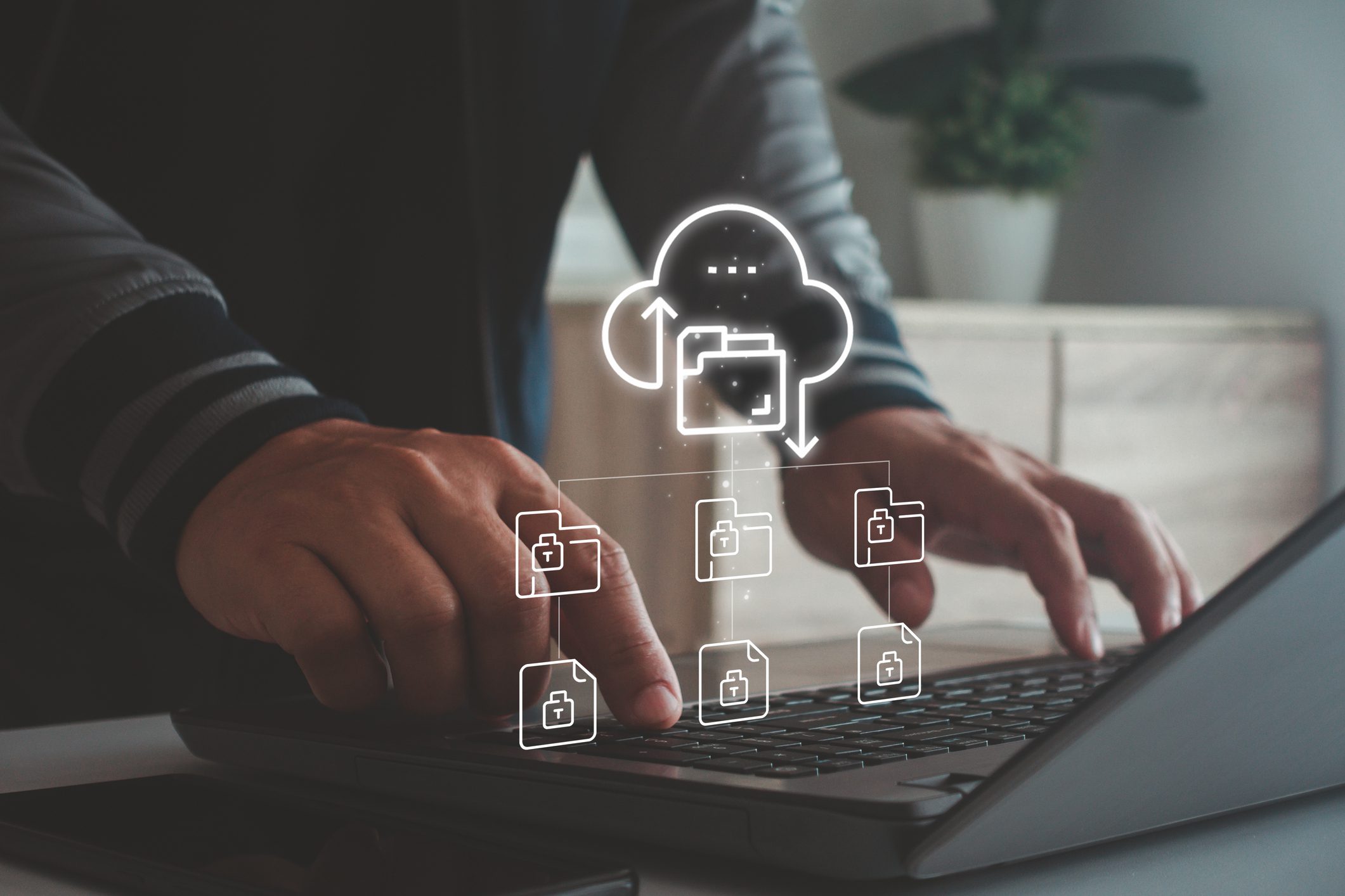 Hands on laptop with cloud file icons